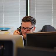 man using IP phone inside room